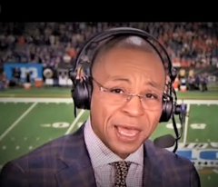 Gus Johnson on the headset at a football game.